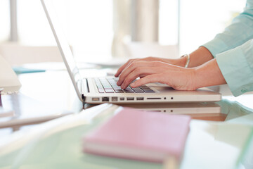 Businesswoman using laptop at desk