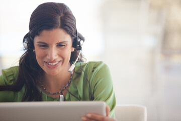 Businesswoman wearing headset at desk