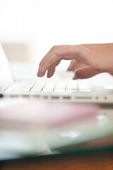 Close up of hand using laptop at desk