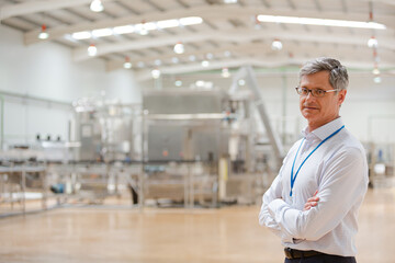 Businessman smiling in factory
