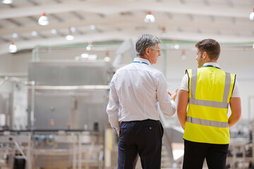 Supervisor and worker talking in warehouse