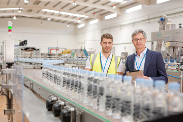 Supervisor and worker smiling in factory