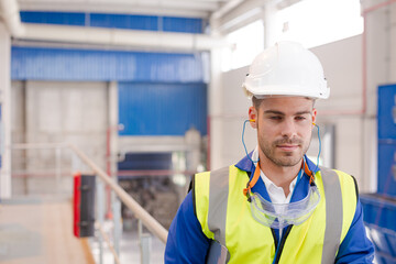 Worker wearing hard hat and ear plugs