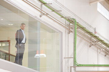 Businessman looking out glass window