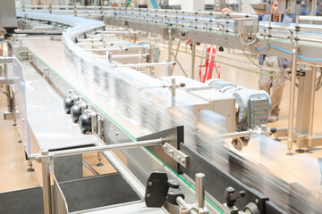 Bottles on conveyor belt in factory