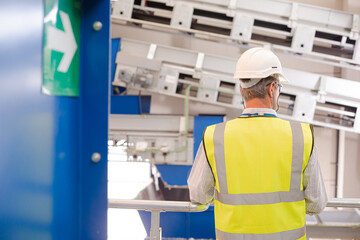 Worker on platform in recycling center