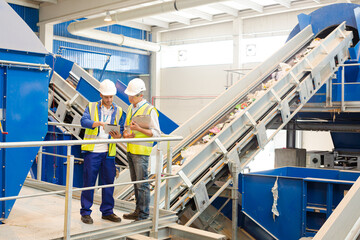 Workers talking in recycling center