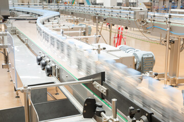 Bottles on conveyor belt in factory