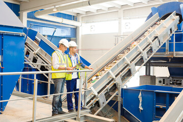 Workers talking in recycling center