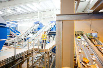 Worker on platform in recycling center