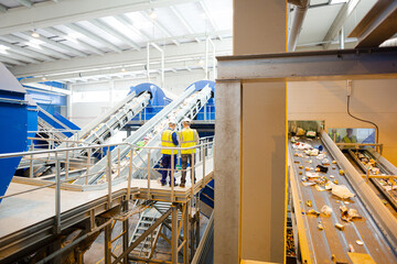 Worker on platform in recycling center
