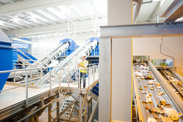 Worker on platform in recycling center