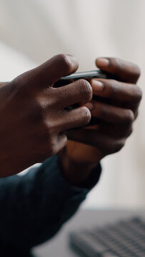 Close Up Of Black Man Hands Playing Online Internet Mobile Video Games On His Phone At Home. Leisure Entertainment Time, Gaming In Free Time On Web Services