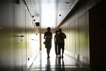 People walking in corridor inside modern building