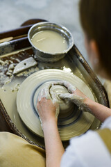 Fototapeta premium making pottery of different shape on pottery wheel