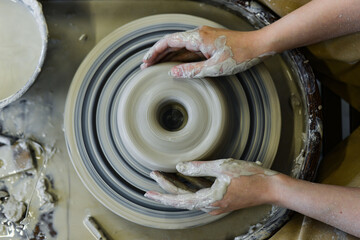 Fototapeta premium making pottery of different shape on pottery wheel