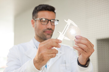 Scientist using caliper