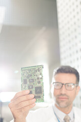 Engineer examining circuit board