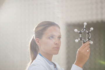 Scientist examining molecule model