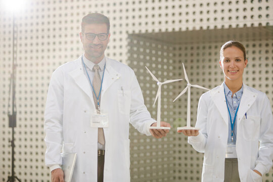 Portrait of scientists holding wind turbine models