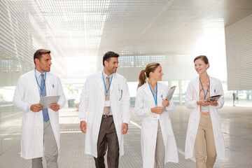 Doctors walking in hospital corridor