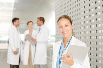 Doctor with clipboard in hospital corridor