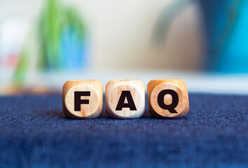 FAQ - concept on a blur background. Wooden cubes