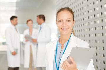Doctor with clipboard in hospital corridor