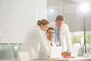 Doctors working at laptop