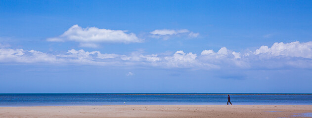 Tropical sandy beach and clear blue sea with beautiful sky with clouds. Summertime
