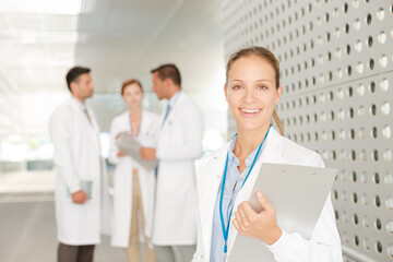 Fototapeta premium Doctor with clipboard in hospital corridor