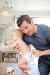 Obraz na płótnie Canvas Father checking baby's diaper