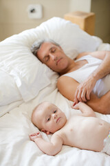 Fototapeta na wymiar Father and baby laying on bed