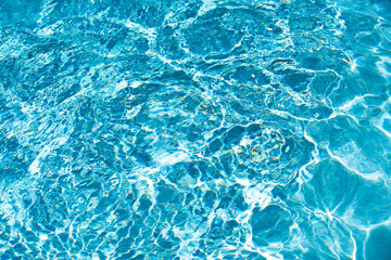 Abstract ripple wave and clear turquoise water surface in swimming pool, blue water wave for background and abstract design.