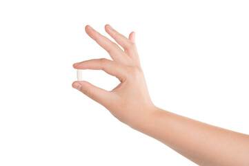 Female hand holding medicine pill isolated on white background