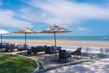 outdoor beach chair and umbrella with seascape beach view with white clouds blue sky at Huahin beach, Thailand, relex vacation in summer