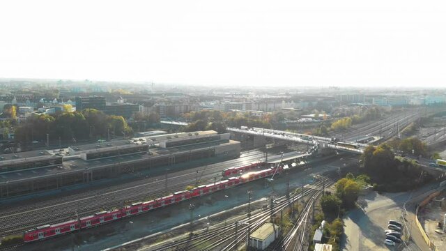 Amezing aerial panoramic view of muenchen city and trains moving on multiple track railway system in Germany. Multiple train tracks on with one train moving on beautiful sunny Day.