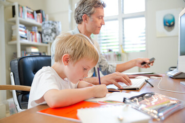 Obraz premium Father and son working in home office