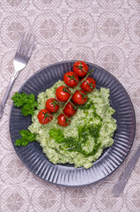 Mashed potatoes with tomatoes and green sauce