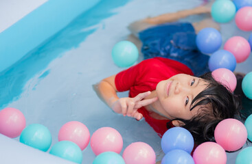 Fototapeta na wymiar kid swimming at the pool, happy time