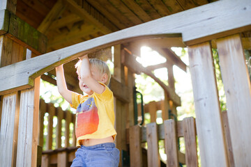 Obraz premium Boy playing on playset outdoors