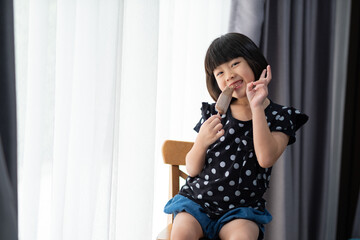 asian girl eating ice cream with blur background