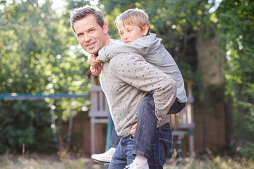 Naklejka na ściany i meble Father and son playing outdoors