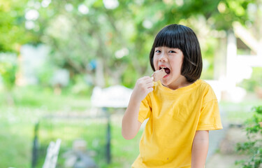 Fototapeta premium asian girl eating ice cream with blur background
