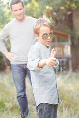 Fototapeta premium Father and son gesturing outdoors