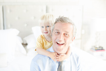 Father and son hugging on bed