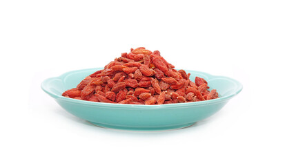 Goji berry in Chinese ceramic dish isolated on white background. Goji berry, or wolfberry. Used in...