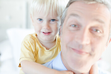 Father and son hugging on bed