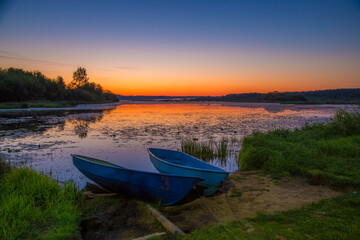 Naklejka na ściany i meble fishermen's boats are laid up at dawn on a clear summer morning