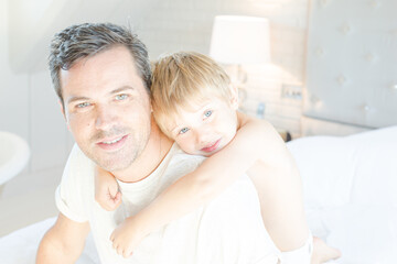 Boy hugging father in bathroom